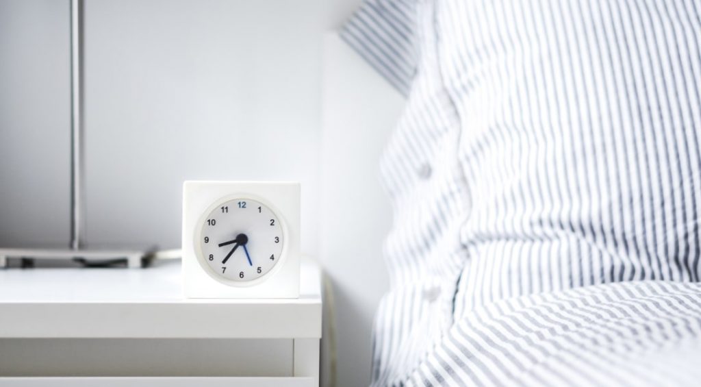 Bed with alarm clock